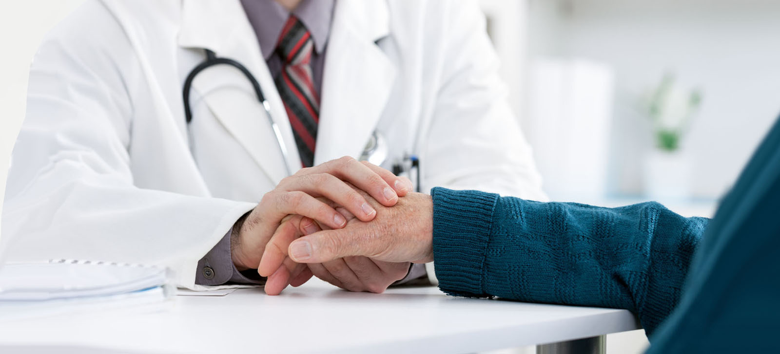 Doctor holding patient’s hand